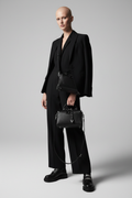 Alluring bald woman carrying the Luxe Bag black pebbled leather doctor bag